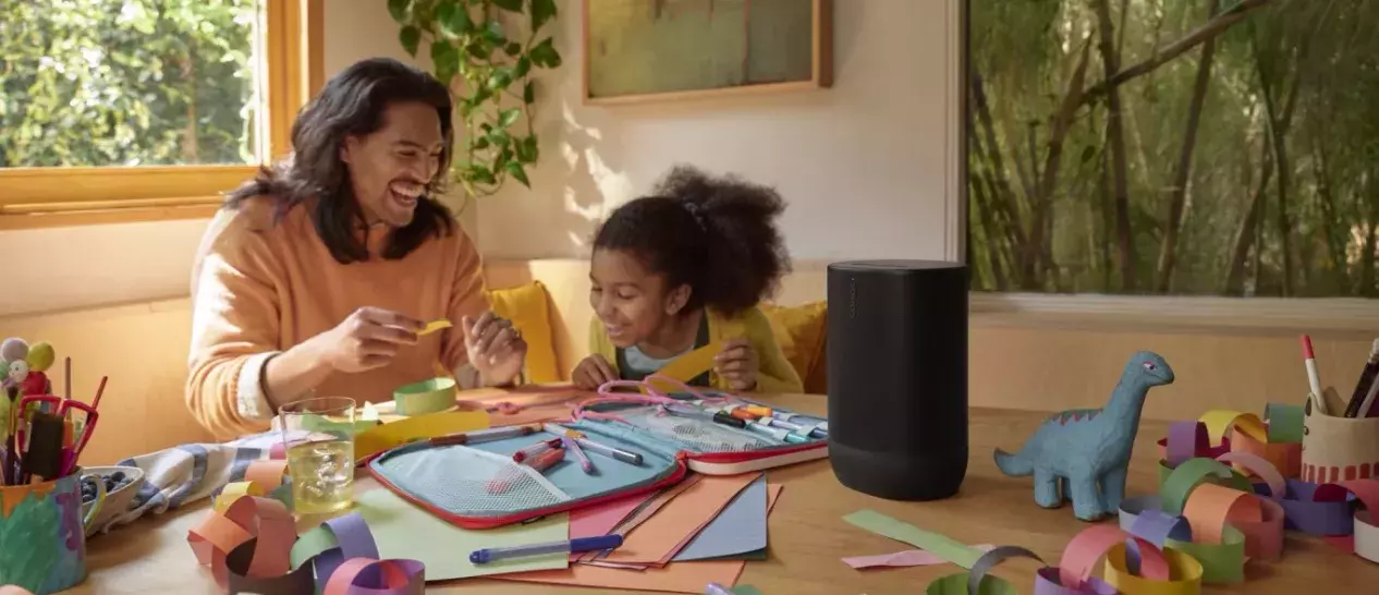 father and daughter laugh and listen to SONOS Move 2