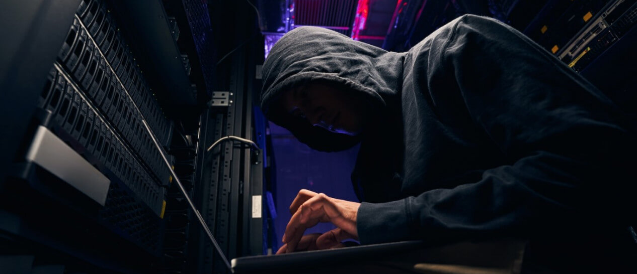 hacker with hoody on laptop