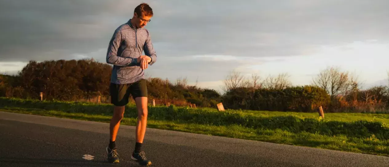 guy runs and uses smartwatch