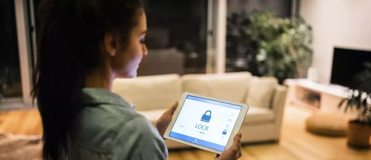 woman using tablet with matter 1.2 connected devices