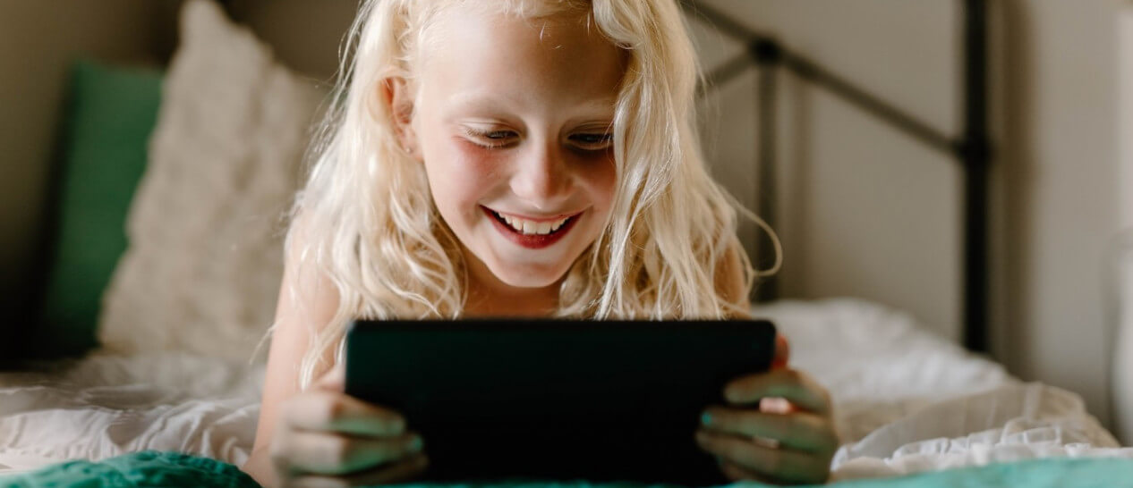young girl playing with tablet