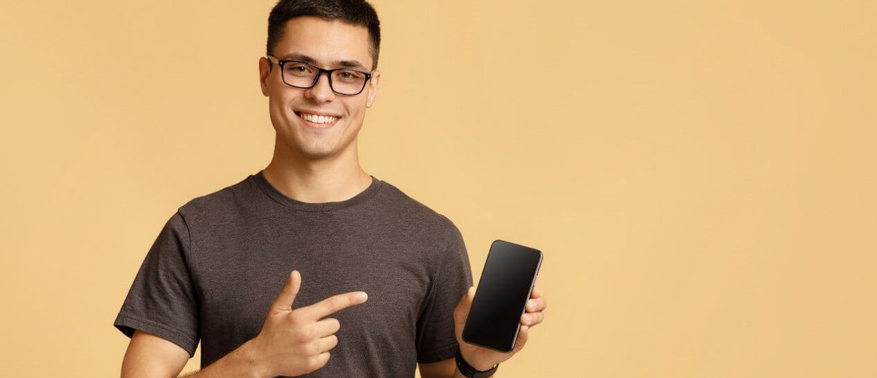 young guy pointing at smartphone