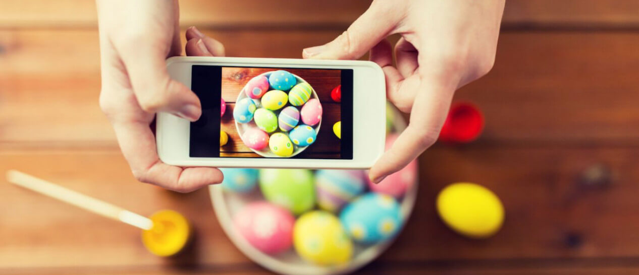 smartphone taking photo of easter eggs