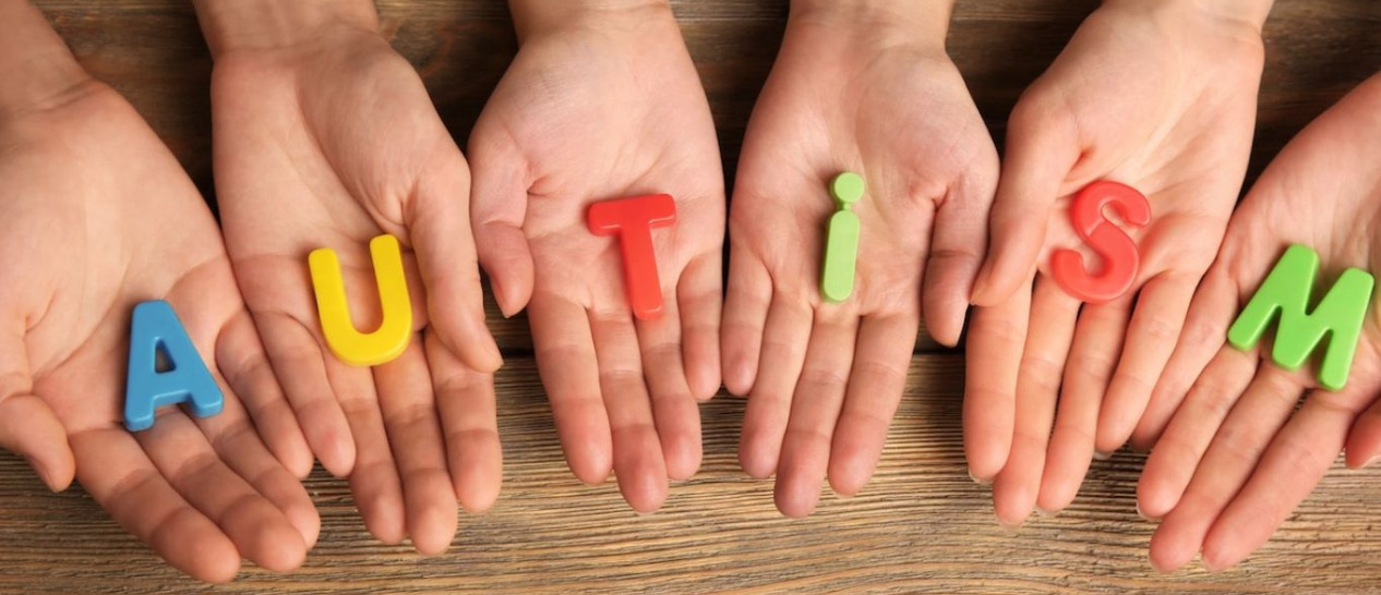 hands holding colorful letters with word autism