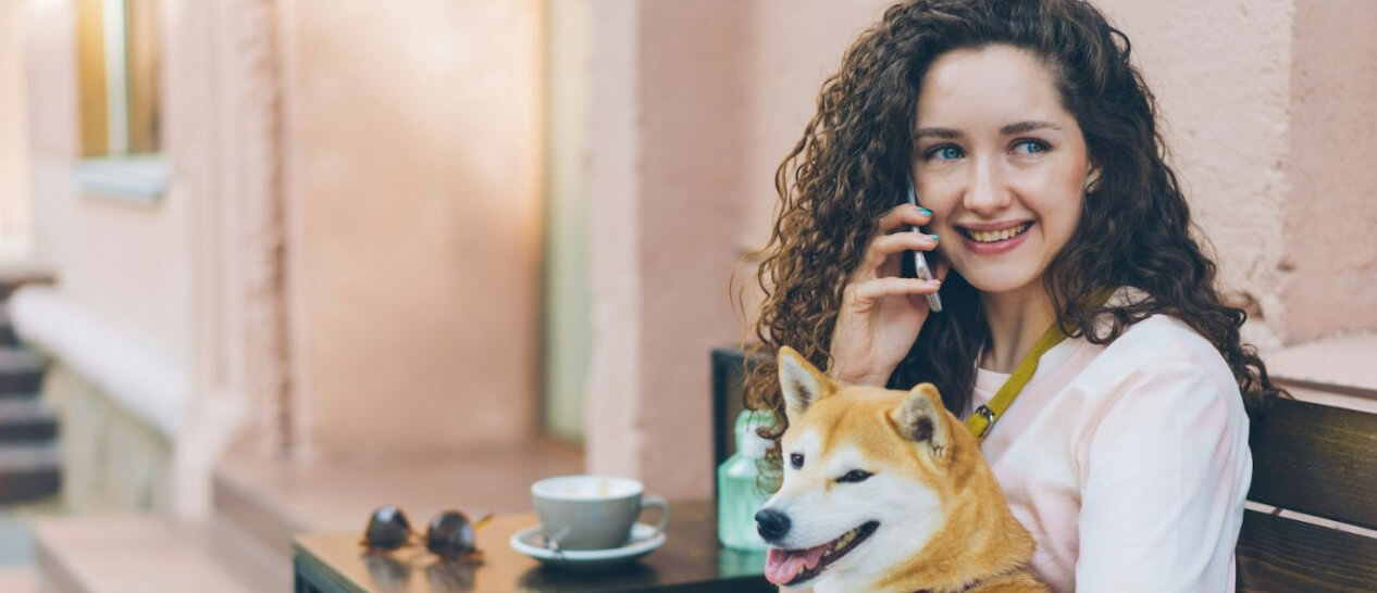 girl with dog and smartphone