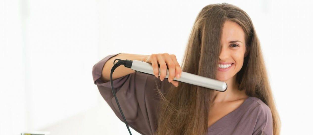 woman with hair straightener