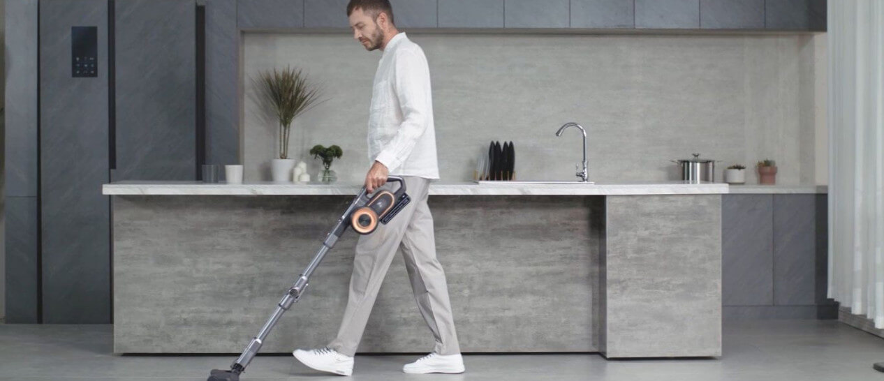 guy using stick vacuum cleaner