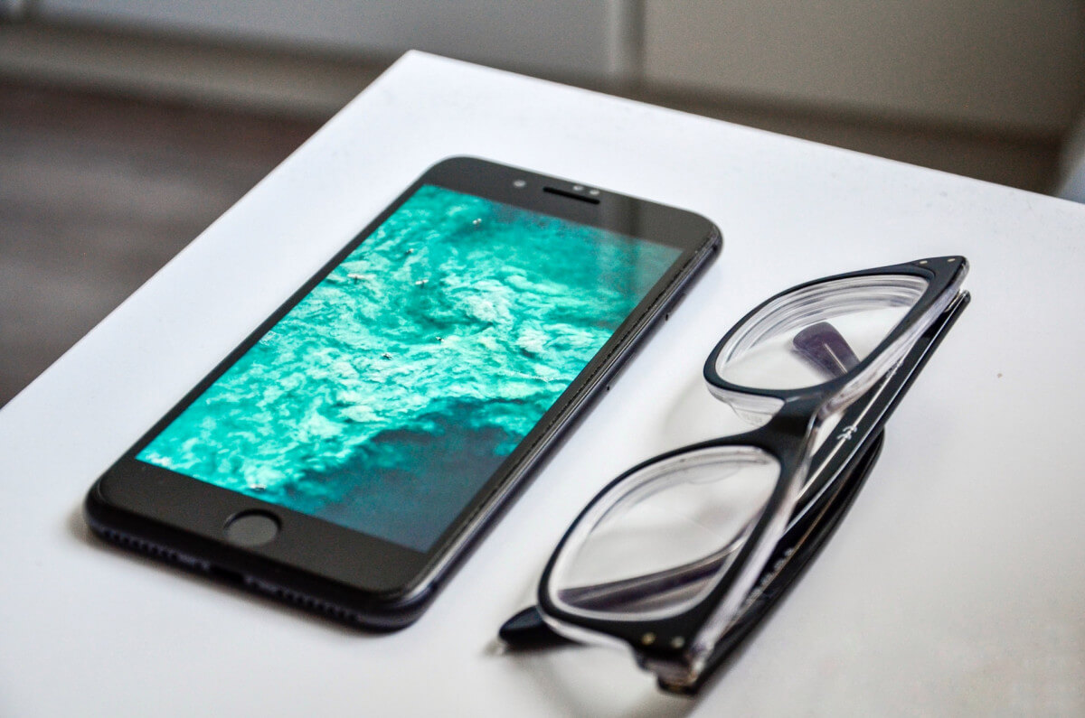 smartphone and glasses on desk