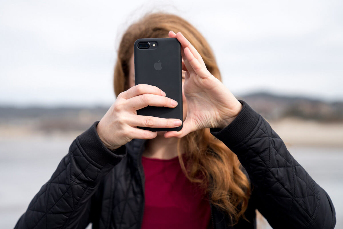 girl taking photo with iPhone