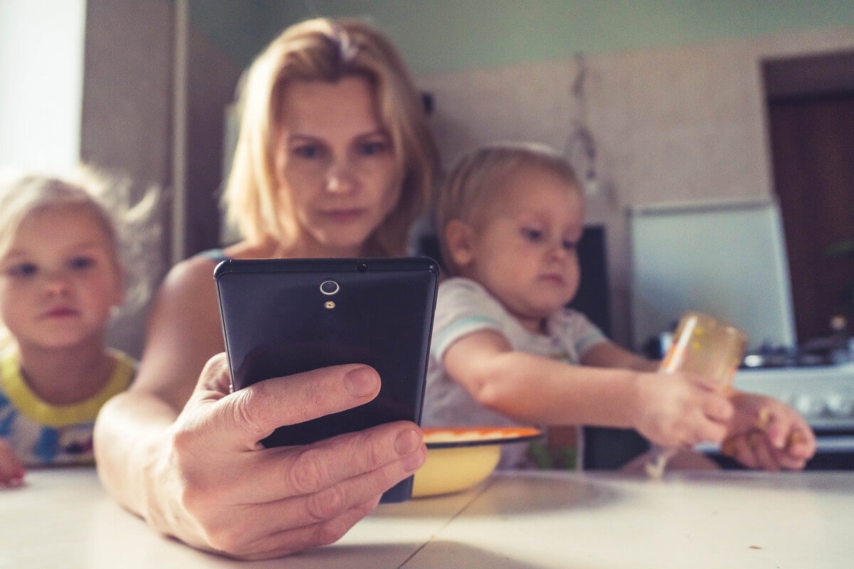 mother with boy and girl using smartphone