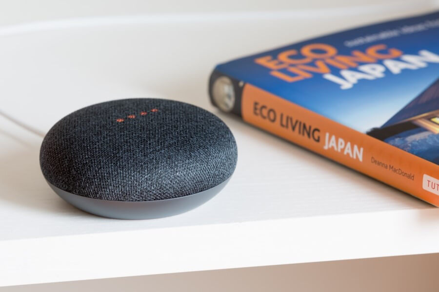 voice assistant on desk next to book