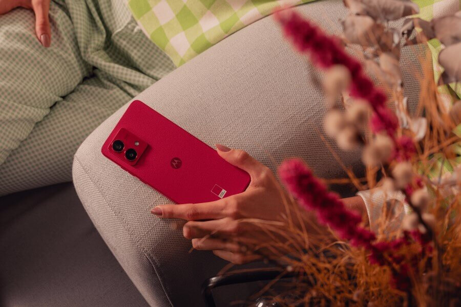 red moto G84 on couch