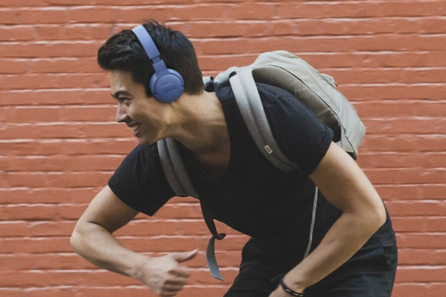 young guy dancing with headphones
