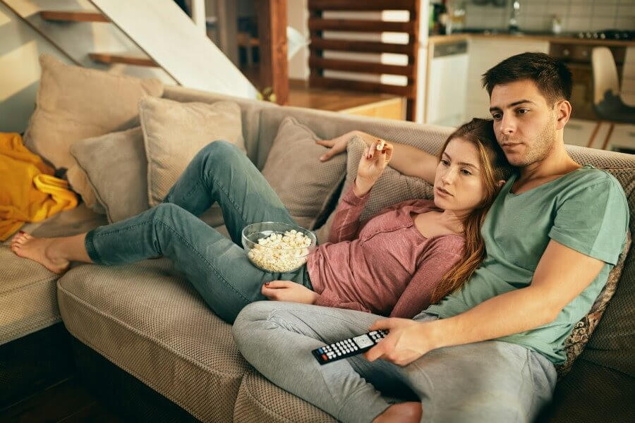 couple watching TV on couch
