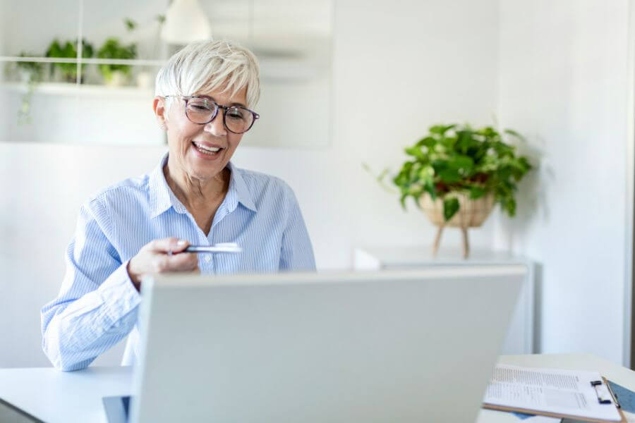 old mother working on laptop