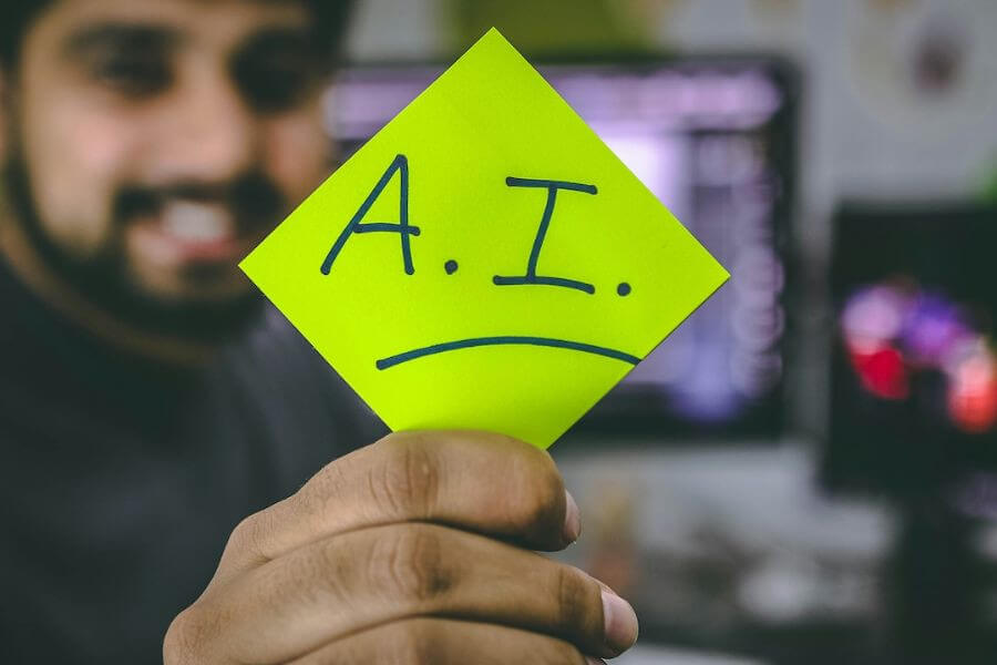 guy smiles holding postit with ai 