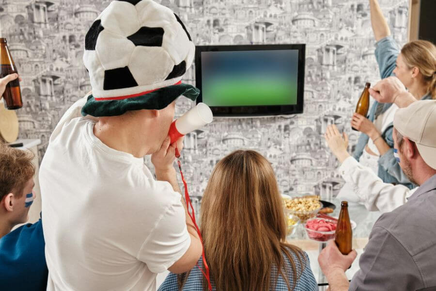 young guy with football hat watching euro 2024