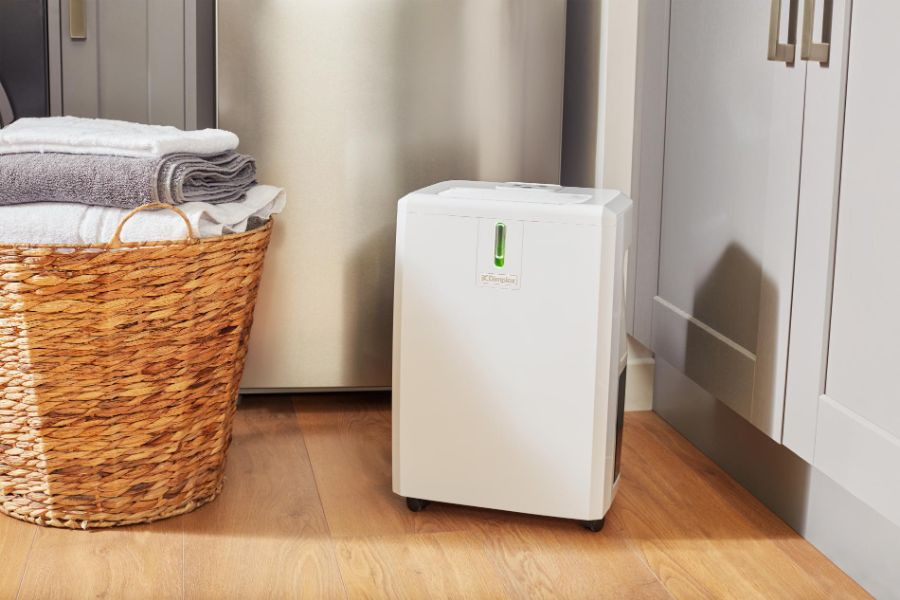 white dehumidifier on corner floor