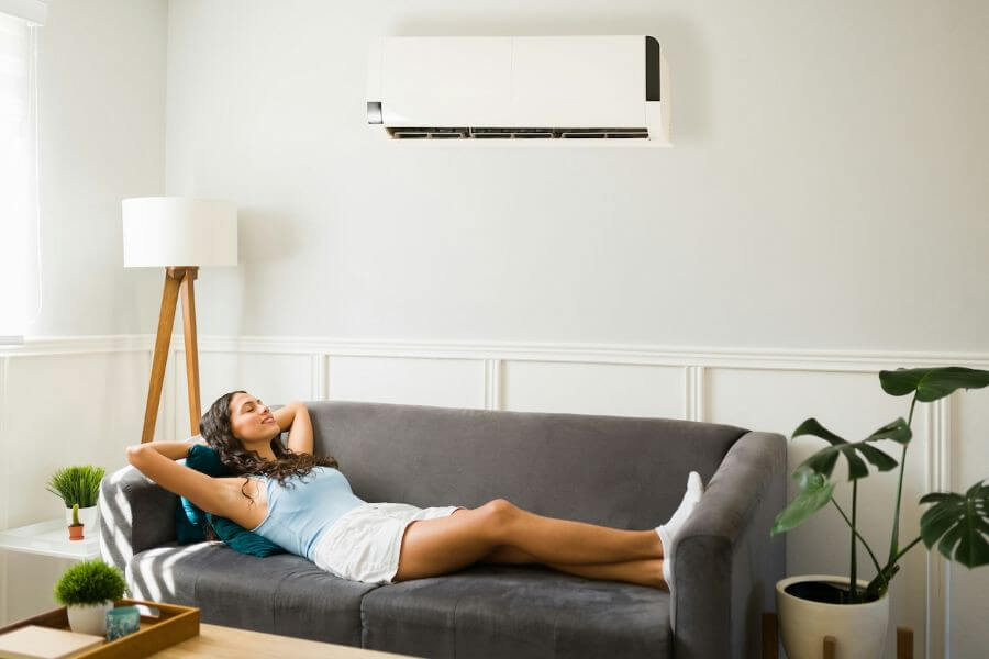 woman lying on sofa with aircondition