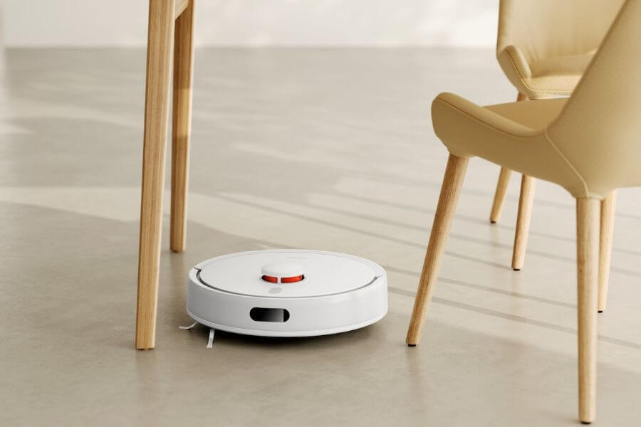 white XIAOMI Robot Vacuum S20 under chair