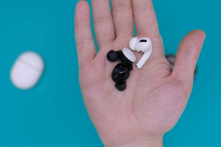 black and white earbuds on hand