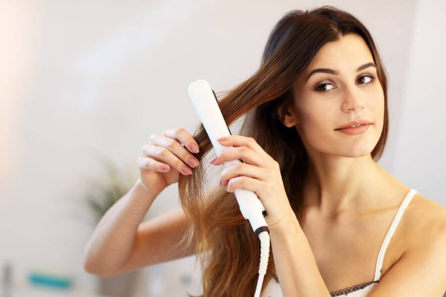 woman with hair straightener