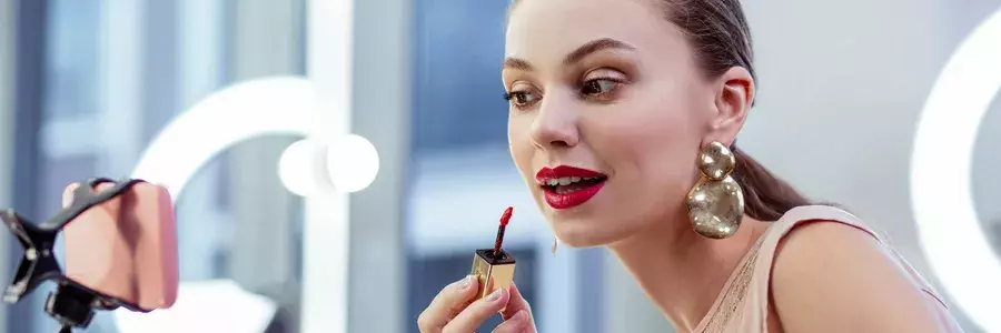 Μία γυναίκα διορθώνει το μακιγιάζ της μπροστά στον έξυπνο καθρέφτη της