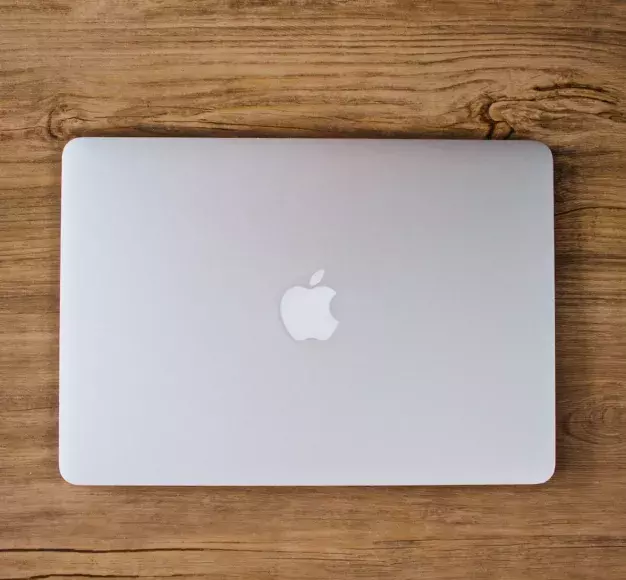 closed macbook on desk