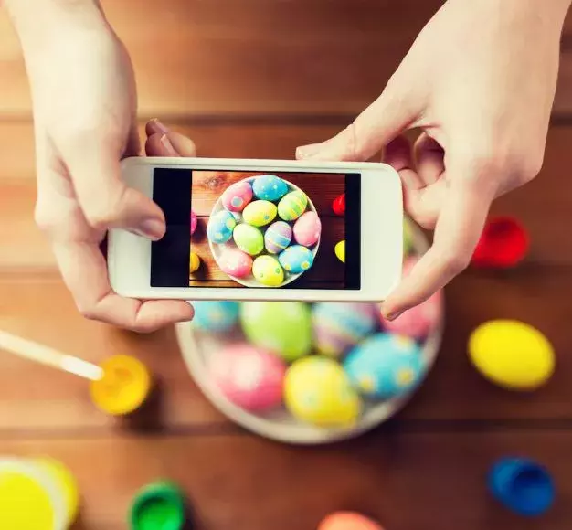 smartphone taking photo of easter eggs